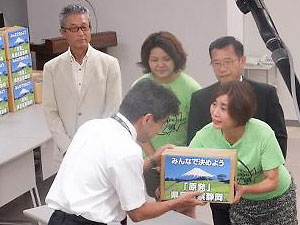 集まった署名を県原子力安全対策課杉浦課長に渡す「原発県民投票静岡」の方々。